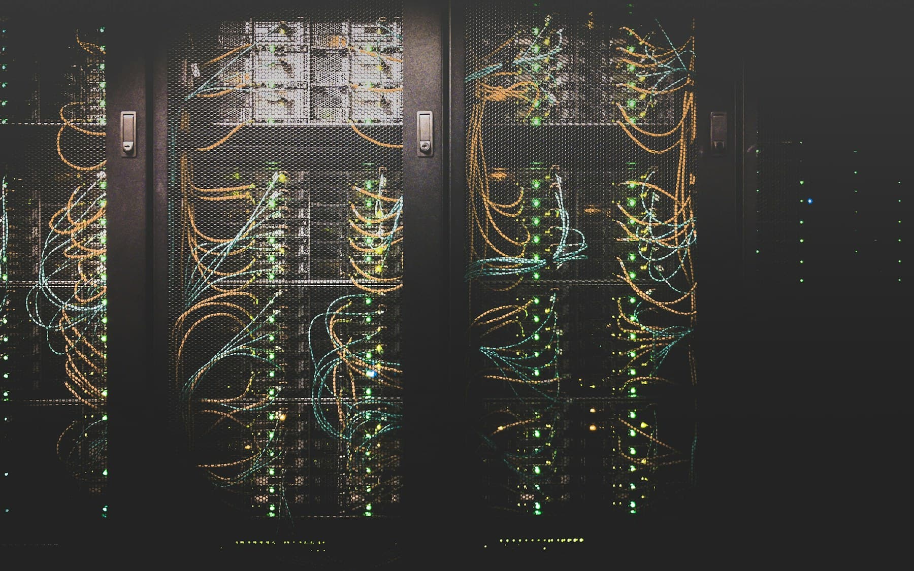 Network racks and illuminated cables representing infrastructure monitoring